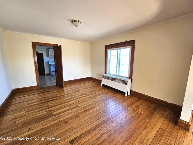 a view of wooden floor in an empty room