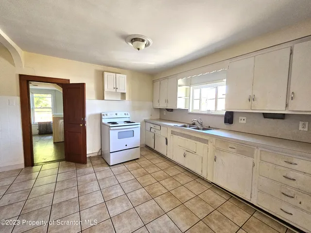 a kitchen with a stove a sink and a refrigerator