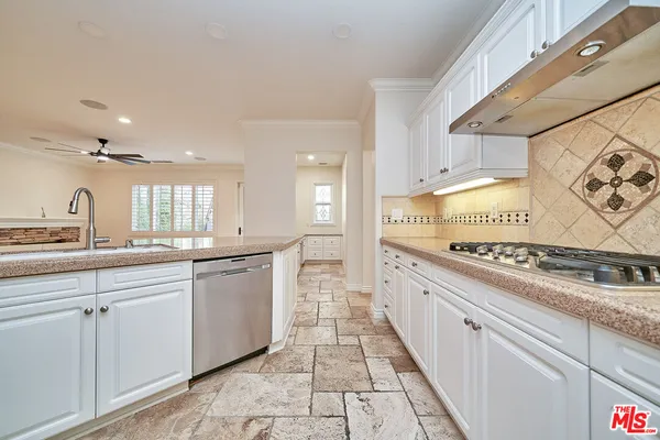 a large white kitchen with a large window