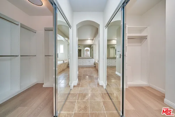 a bathroom with a glass shower door and a mirror