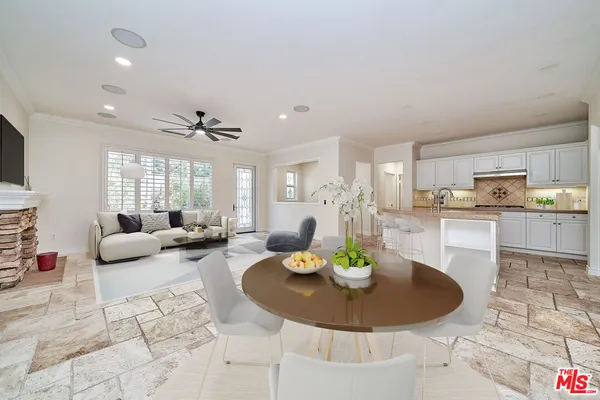 a living room with furniture and kitchen view