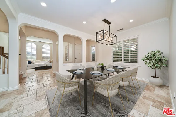 a view of a dining room with furniture and a chandelier