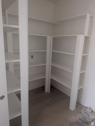 2771 West Aurora Avenue Mapleton, UT 84664 - Photo 12 of 39 White storage shelving system featuring multiple tiers of shelving, L-shaped configuration, and wood-finish flooring
