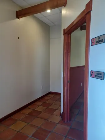 a view of a room with wooden floor and windows