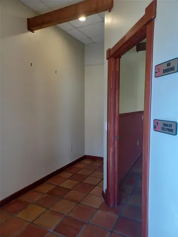 a view of a room with wooden floor and windows