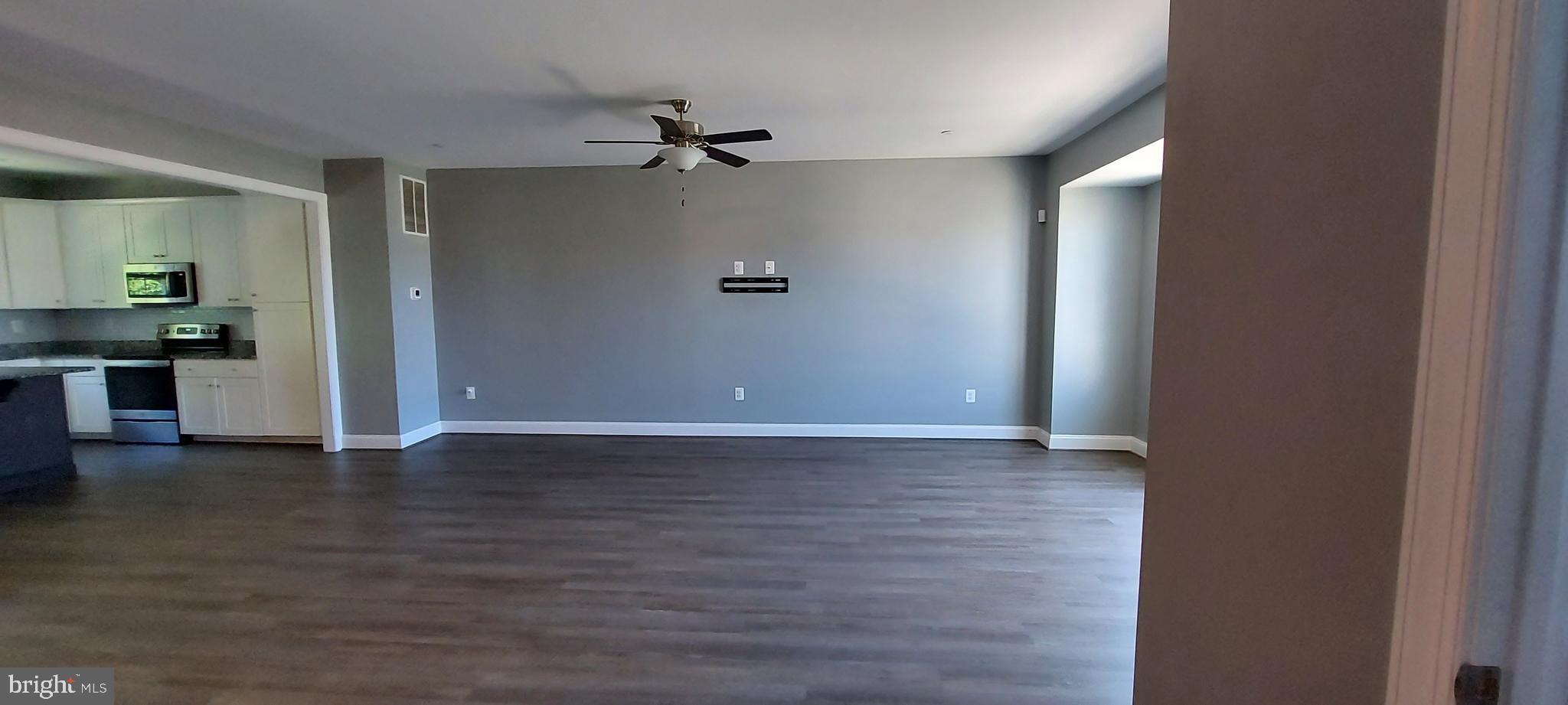 1056 Rye Drive La Plata, MD 20646 - Photo 12 of 23 an empty room with wooden floor cabinet and windows