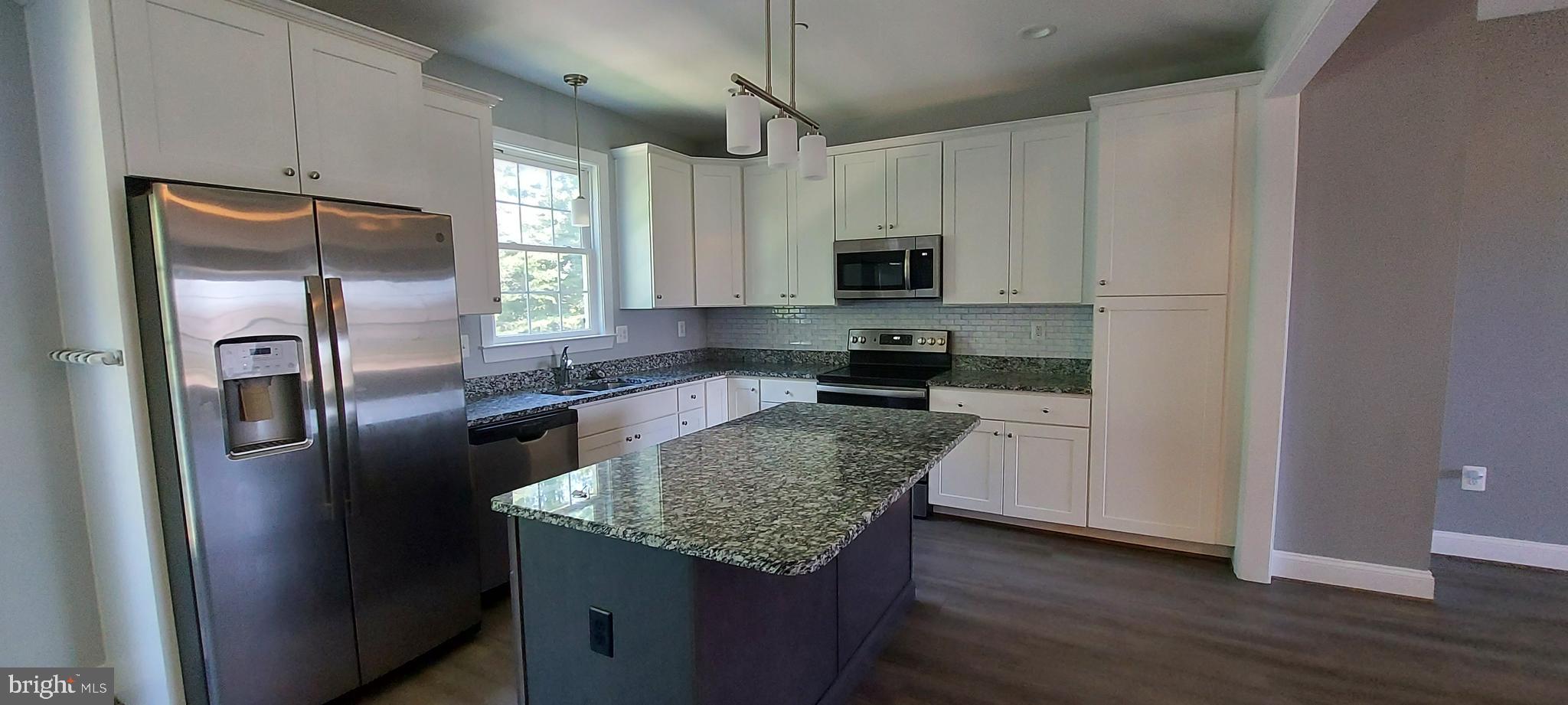 1056 Rye Drive La Plata, MD 20646 - Photo 14 of 23 a kitchen with granite countertop a refrigerator a sink a stove a microwave and wooden floor