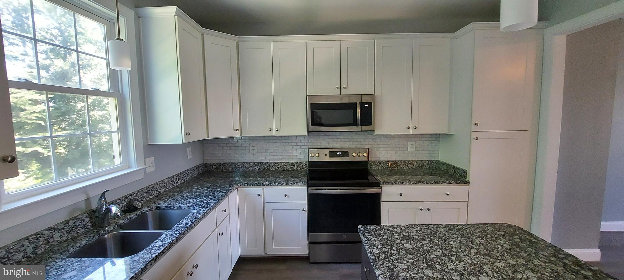 1056 Rye Drive La Plata, MD 20646 - Photo 16 of 23 a kitchen with stainless steel appliances granite countertop a stove a sink and a microwave
