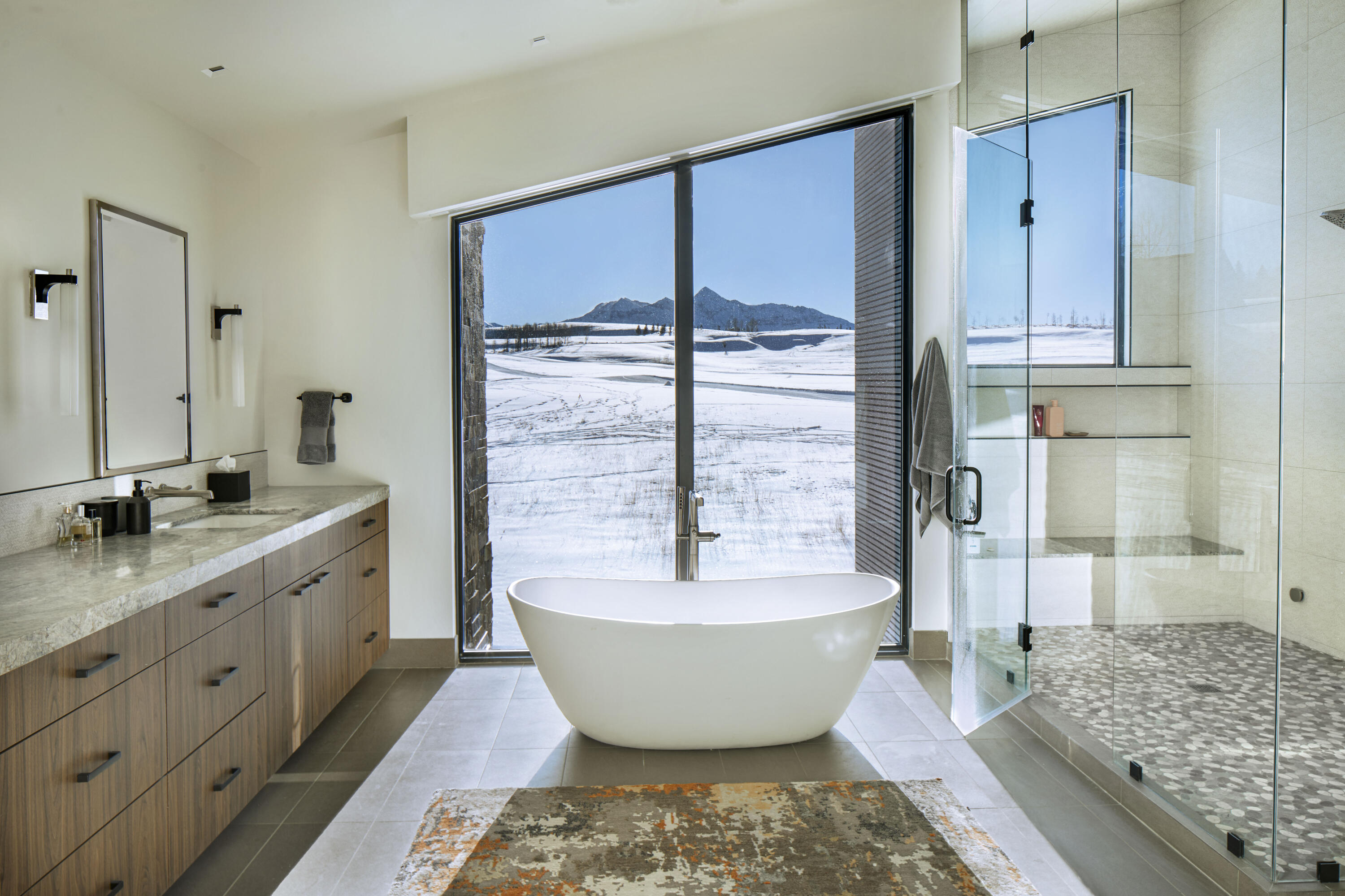 167 Adams Ranch Road Mountain Village, CO 81435 - Photo 18 of 28 a spacious bathroom with a granite countertop tub sink and mirror