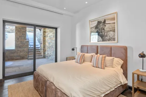 a bedroom with two beds and a large window