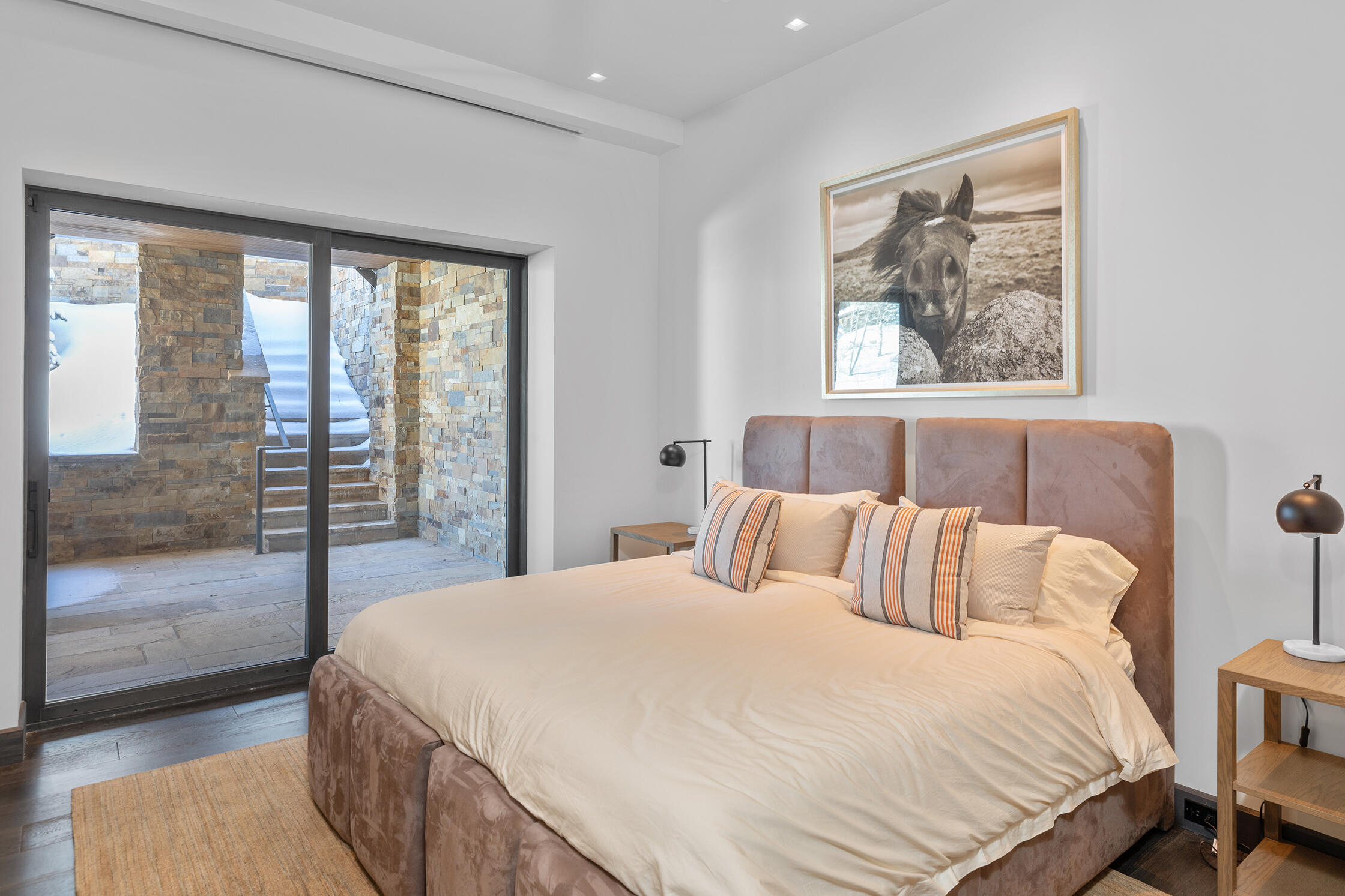 167 Adams Ranch Road Mountain Village, CO 81435 - Photo 20 of 28 a bedroom with a large bed and a large window