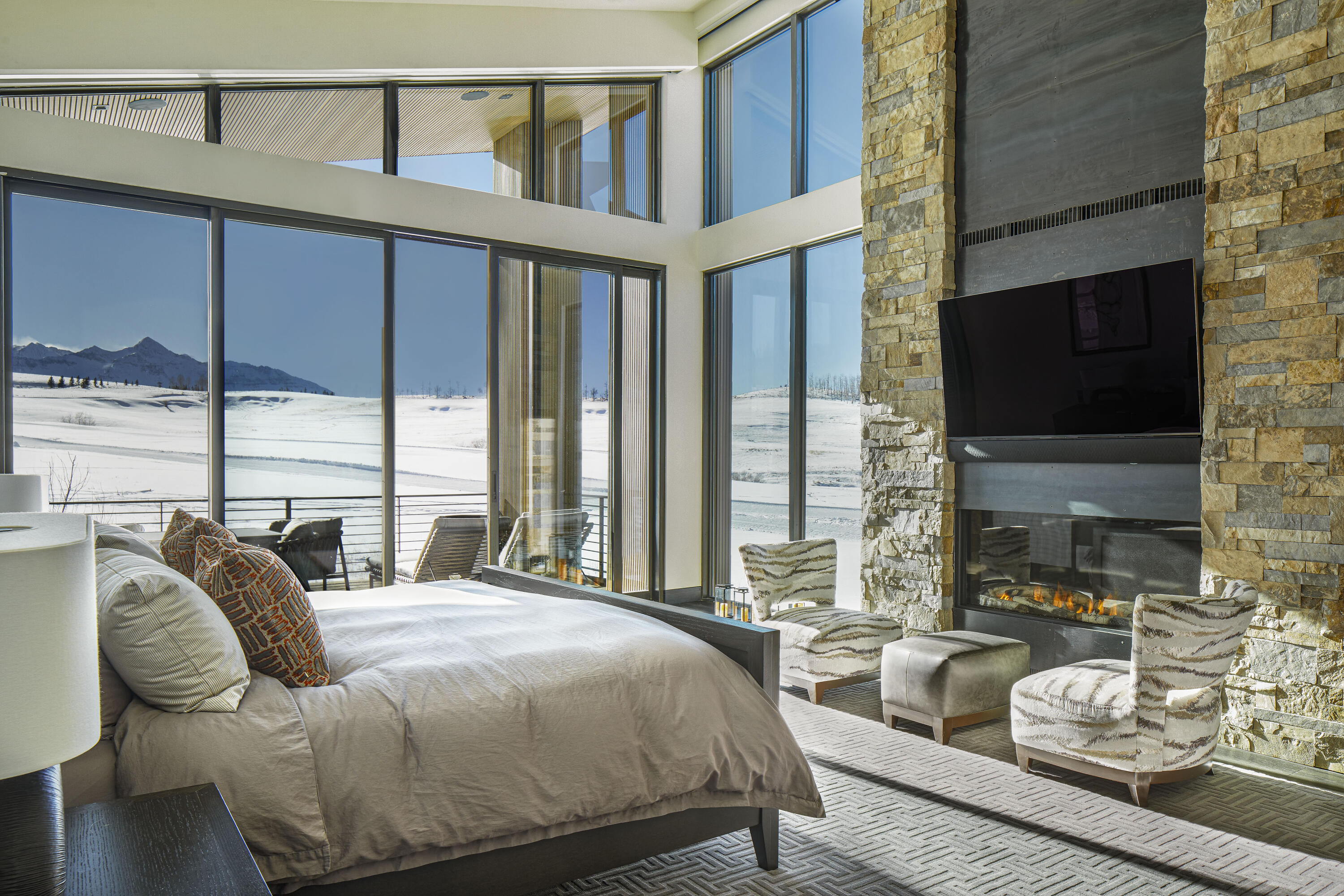 167 Adams Ranch Road Mountain Village, CO 81435 - Photo 4 of 28 a bedroom with furniture a flat screen tv and a large window