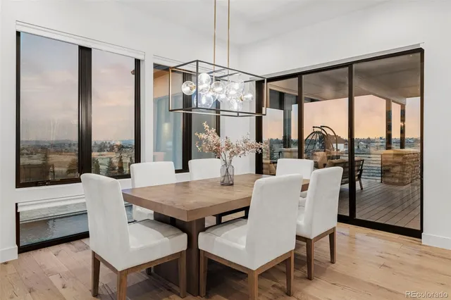a dining room with furniture a chandelier and wooden floor