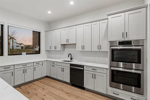 a kitchen with cabinets appliances and a window