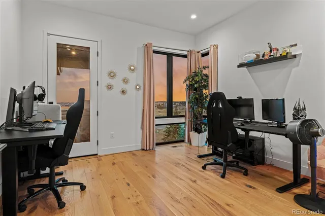 a view of a workspace with furniture and gym equipment