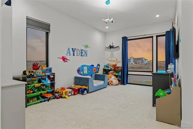 a children room with toys and a chandelier
