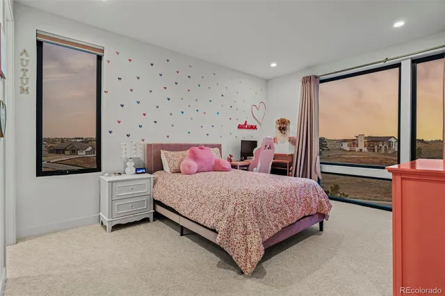 a bedroom with a bed and large window