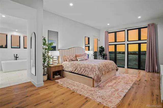 a bedroom with a large bed and a large window