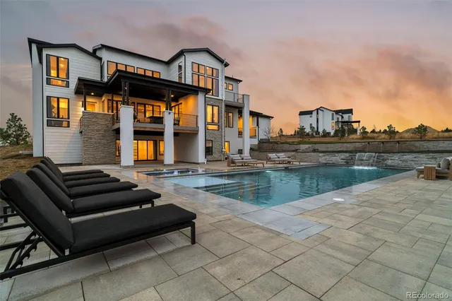 a roof deck with a table and chairs