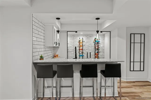 a kitchen with a sink and chairs