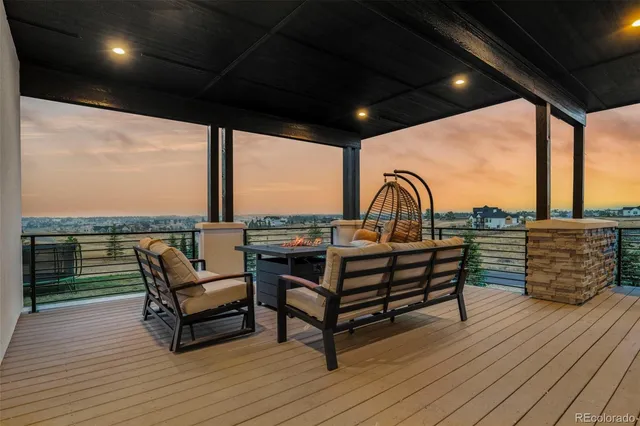 a roof deck with a table and chairs