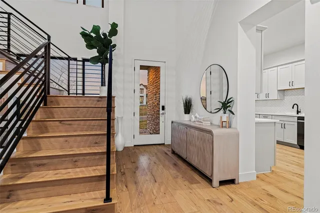a view of entryway and hall with wooden floor