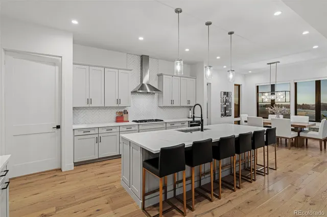 a large kitchen with lots of counter space a sink appliances and cabinets