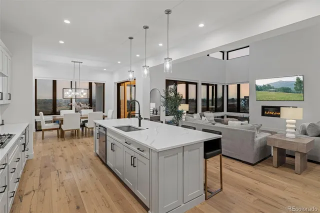a large white kitchen with a table and chairs