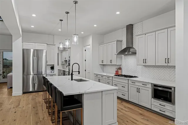 a kitchen with a sink a stove a refrigerator and cabinets