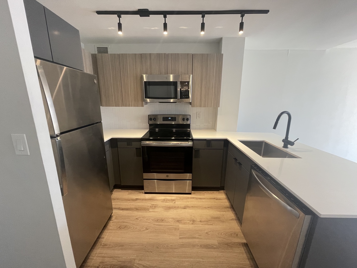 Undisclosed Address Chicago, IL 60611 - Photo 3 of 13 a kitchen with stainless steel appliances a refrigerator a sink a stove a microwave and cabinets
