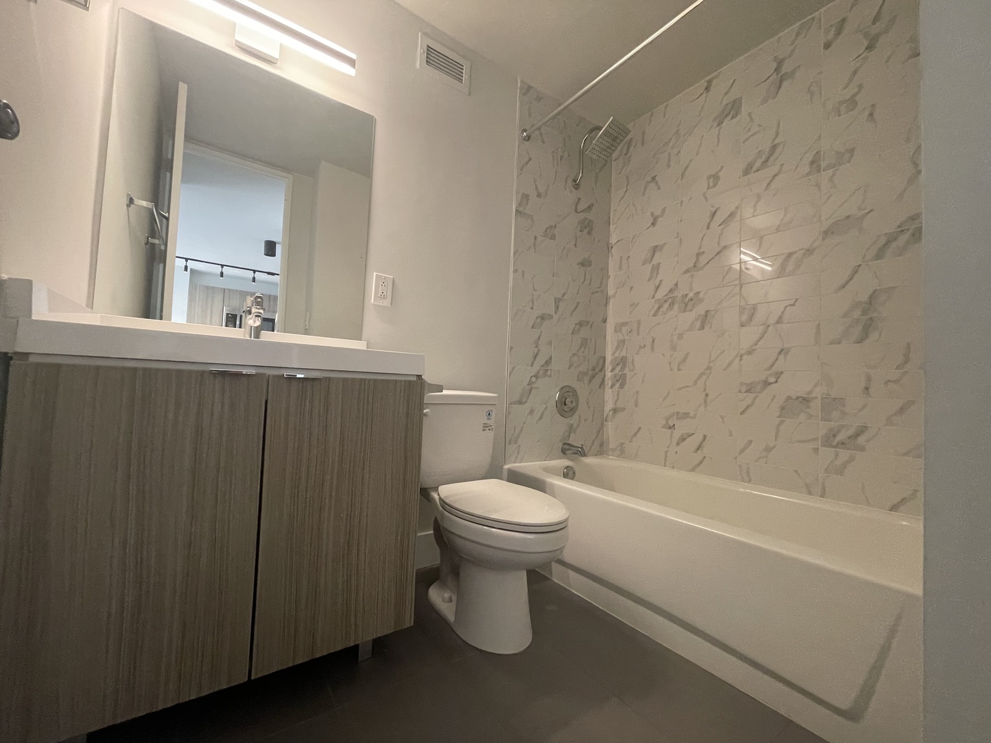 Undisclosed Address Chicago, IL 60611 - Photo 4 of 13 a bathroom with a toilet a sink and bathtub