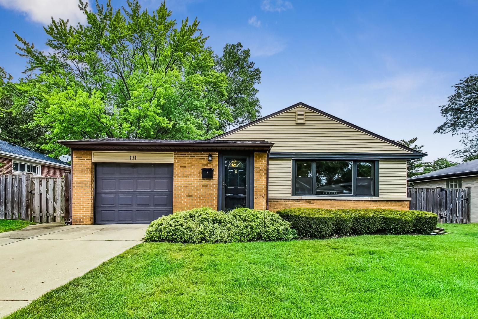 111 South We Go Trail Mount Prospect, IL 60056 - Photo 1 of 46 a front view of a house with a yard and garage