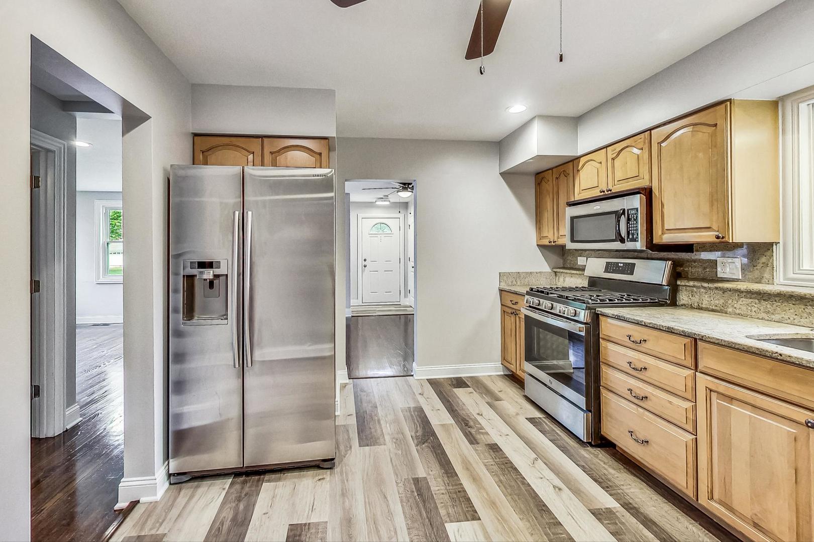 111 South We Go Trail Mount Prospect, IL 60056 - Photo 11 of 46 a kitchen with stainless steel appliances a refrigerator sink and cabinets