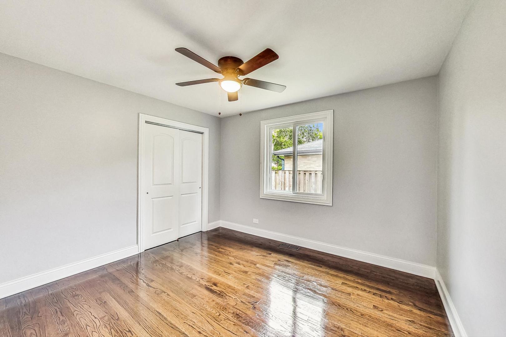 111 South We Go Trail Mount Prospect, IL 60056 - Photo 14 of 46 wooden floor in an empty room with a window