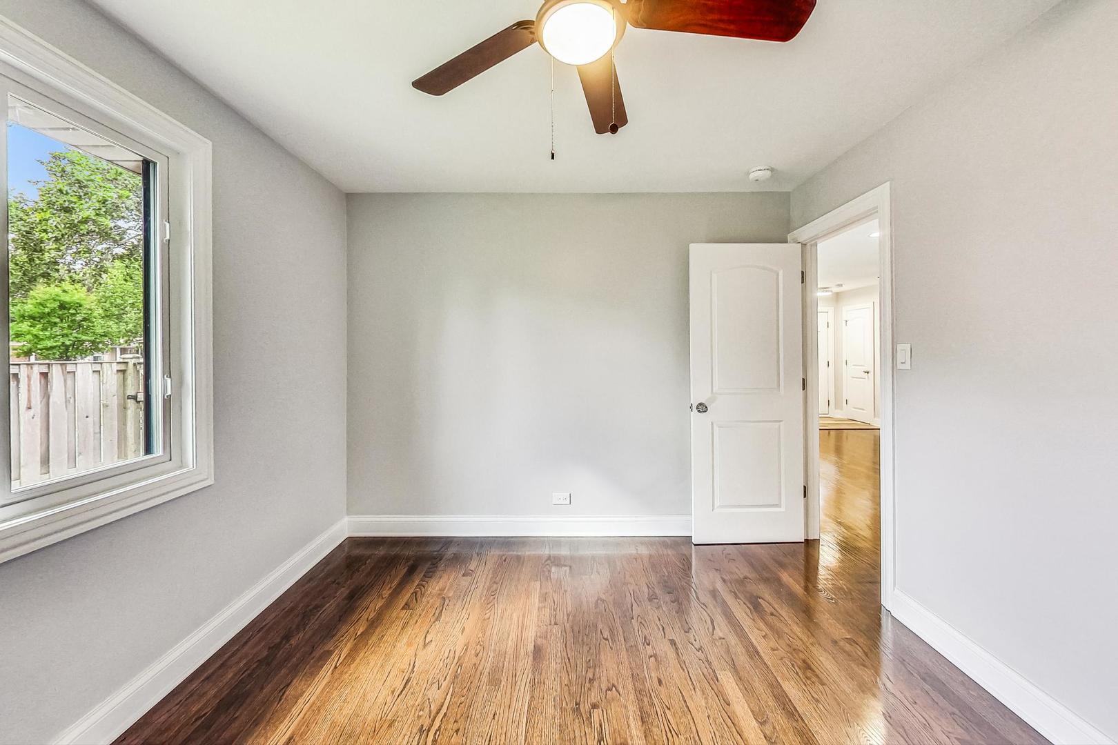 111 South We Go Trail Mount Prospect, IL 60056 - Photo 16 of 46 a view of empty room with wooden floor and fan