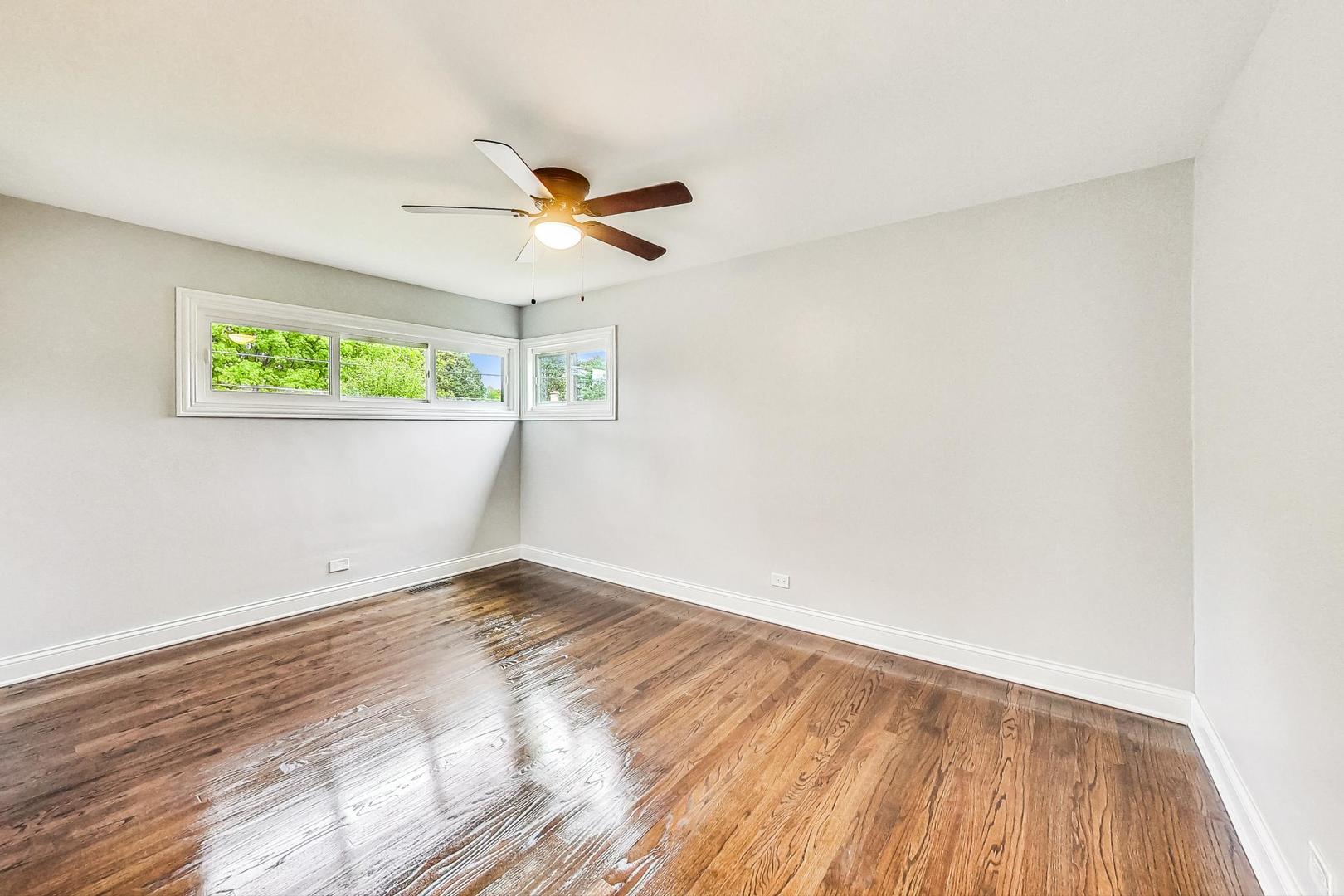 111 South We Go Trail Mount Prospect, IL 60056 - Photo 18 of 46 a view of empty room with wooden floor and fan