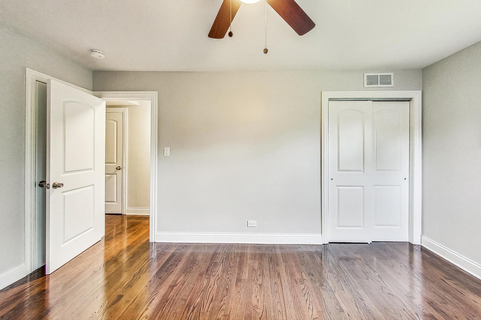 111 South We Go Trail Mount Prospect, IL 60056 - Photo 19 of 46 an empty room with wooden floor cabinet and windows