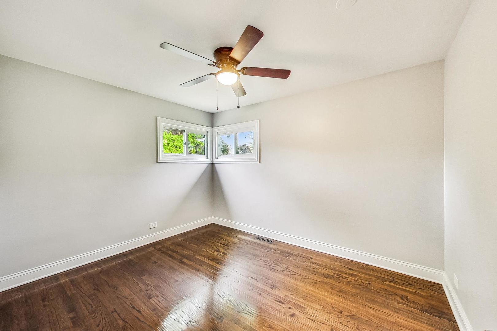 111 South We Go Trail Mount Prospect, IL 60056 - Photo 21 of 46 an empty room with windows and ceiling fan