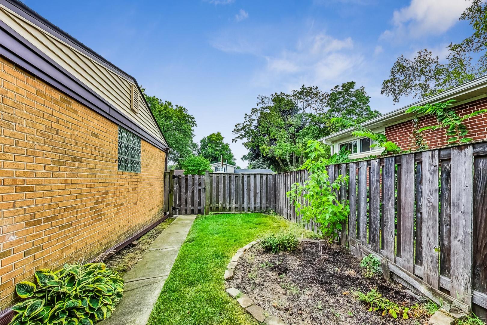 111 South We Go Trail Mount Prospect, IL 60056 - Photo 38 of 46 a view of a backyard with potted plants and wooden fence