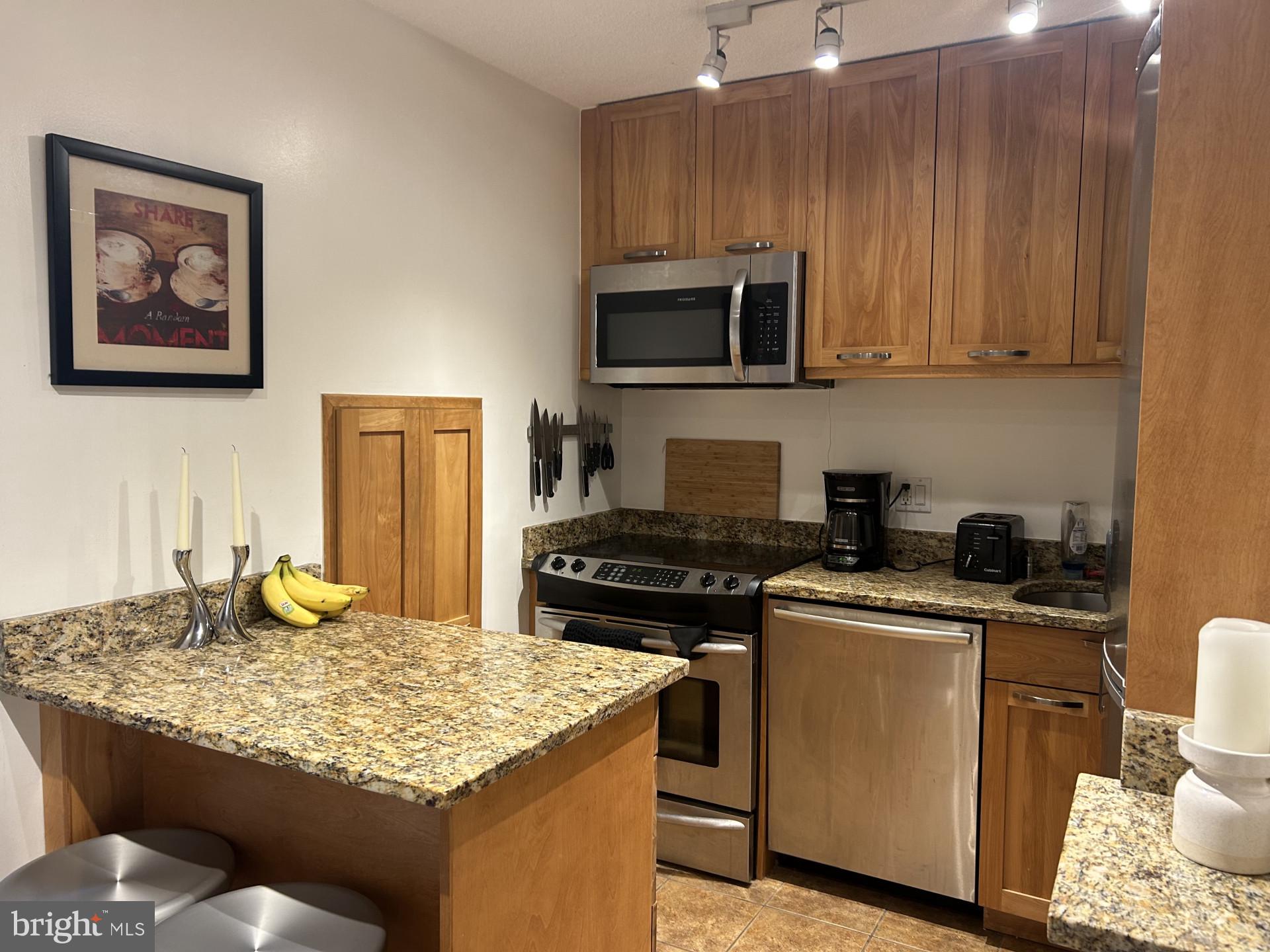 1800 R Street Northwest, Unit 808 Washington, DC 20009 - Photo 3 of 10 a kitchen with a sink stove and microwave