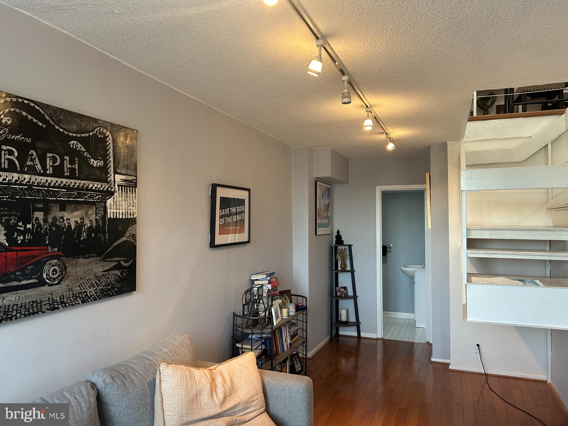 1800 R Street Northwest, Unit 808 Washington, DC 20009 - Photo 5 of 10 a living room with furniture and a wooden floor