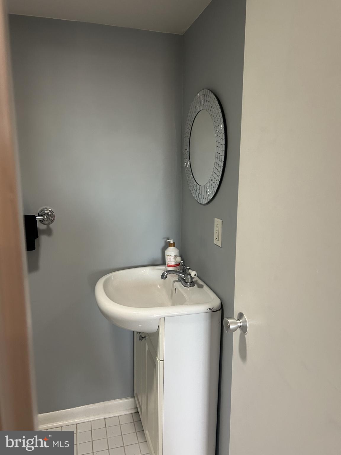1800 R Street Northwest, Unit 808 Washington, DC 20009 - Photo 6 of 10 a bathroom with a sink and a mirror