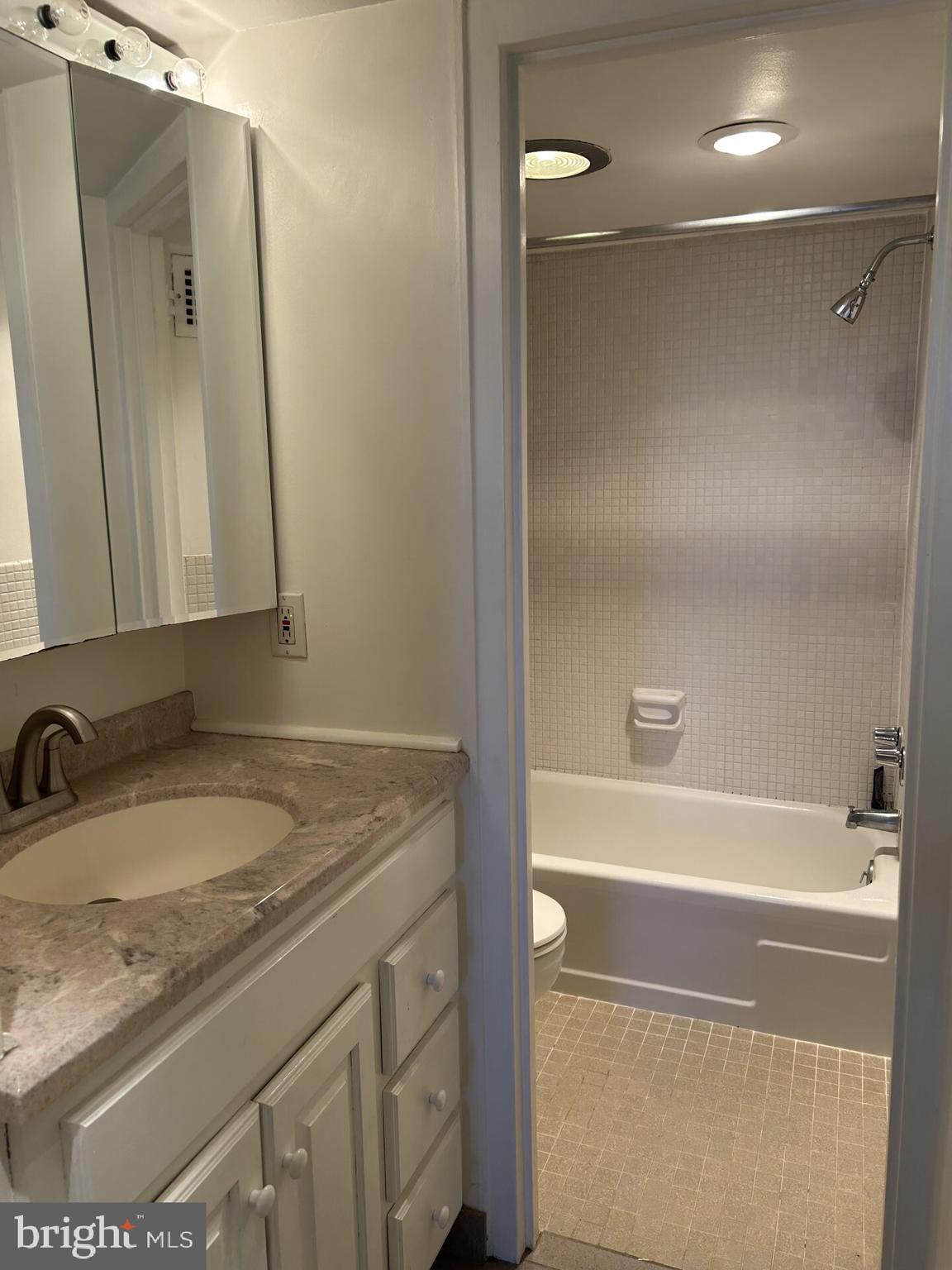 1800 R Street Northwest, Unit 808 Washington, DC 20009 - Photo 10 of 10 a bathroom with a granite countertop sink and a mirror