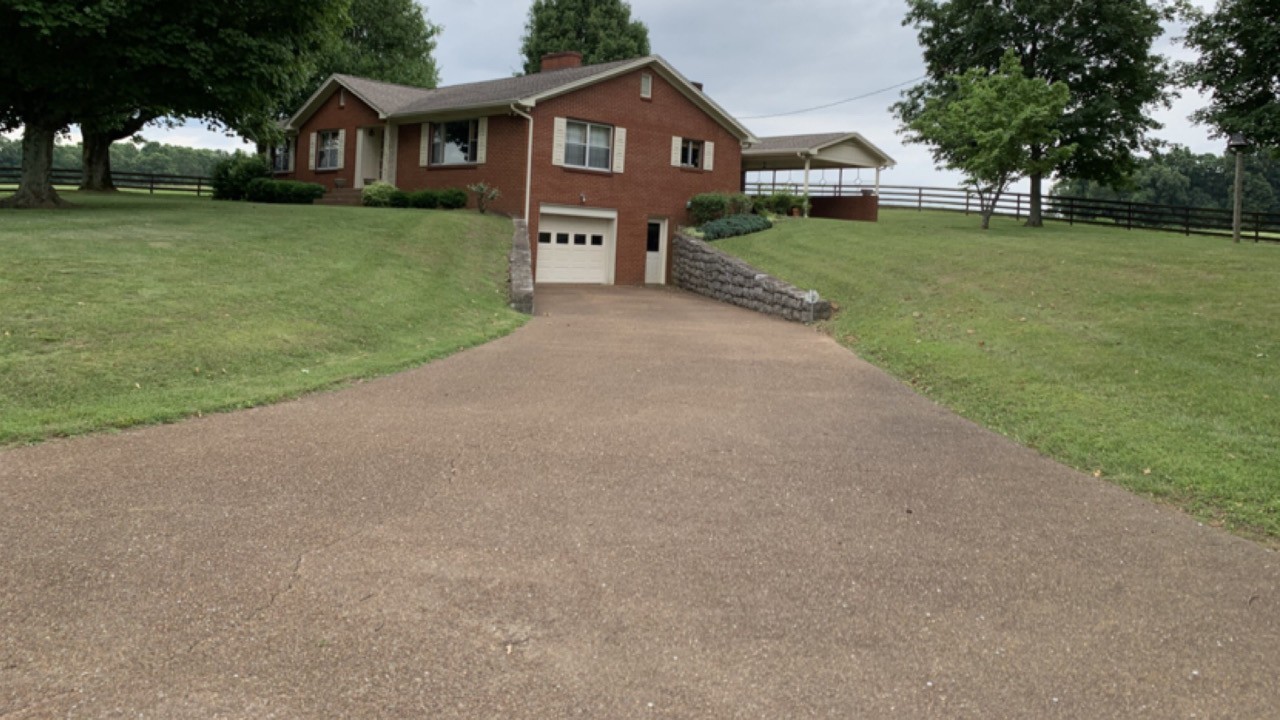 7129 Highland Road Portland, TN 37148 - Photo 2 of 35 a front view of a house with a yard and trees