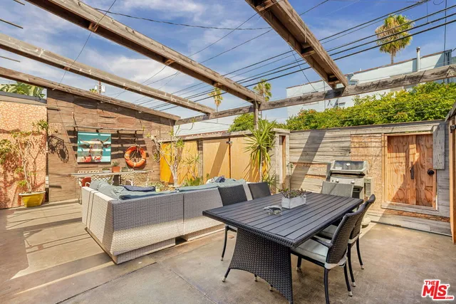 a view of a table and chairs in a patio
