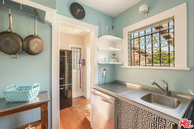 a kitchen with a refrigerator and a sink