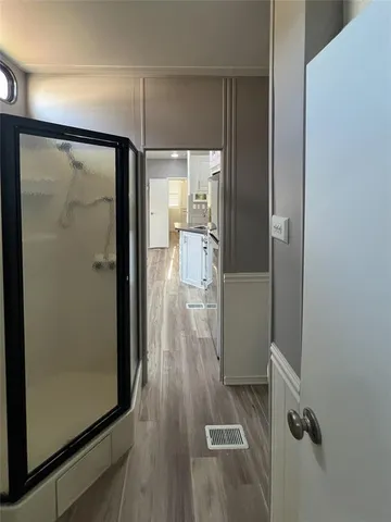 a bathroom with a glass shower door