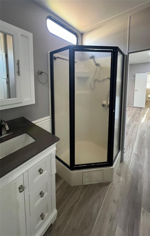 6501 Southeast 55th Lane, Unit 6501 Okeechobee, FL 34974 - Photo 13 of 15 a bathroom with a granite countertop sink a mirror and shower