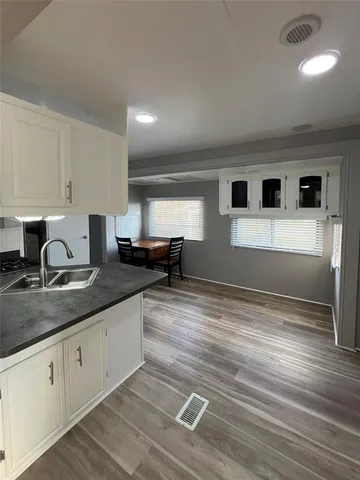 a kitchen with stainless steel appliances granite countertop a sink and cabinets