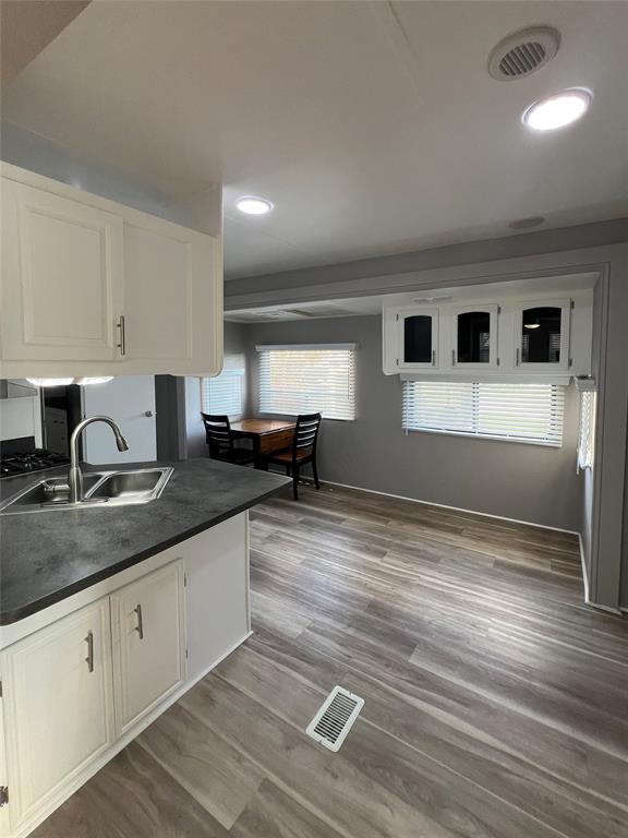 6501 Southeast 55th Lane, Unit 6501 Okeechobee, FL 34974 - Photo 5 of 15 a kitchen with stainless steel appliances granite countertop a sink and cabinets